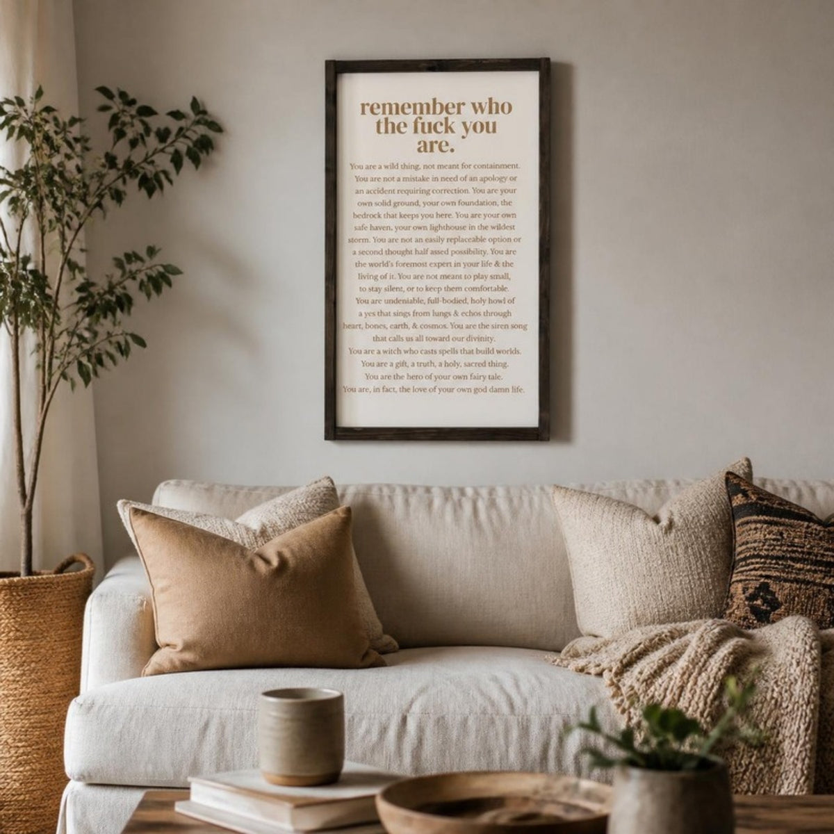 Remember who the fuck you are 12x24 framed sign above a sofa