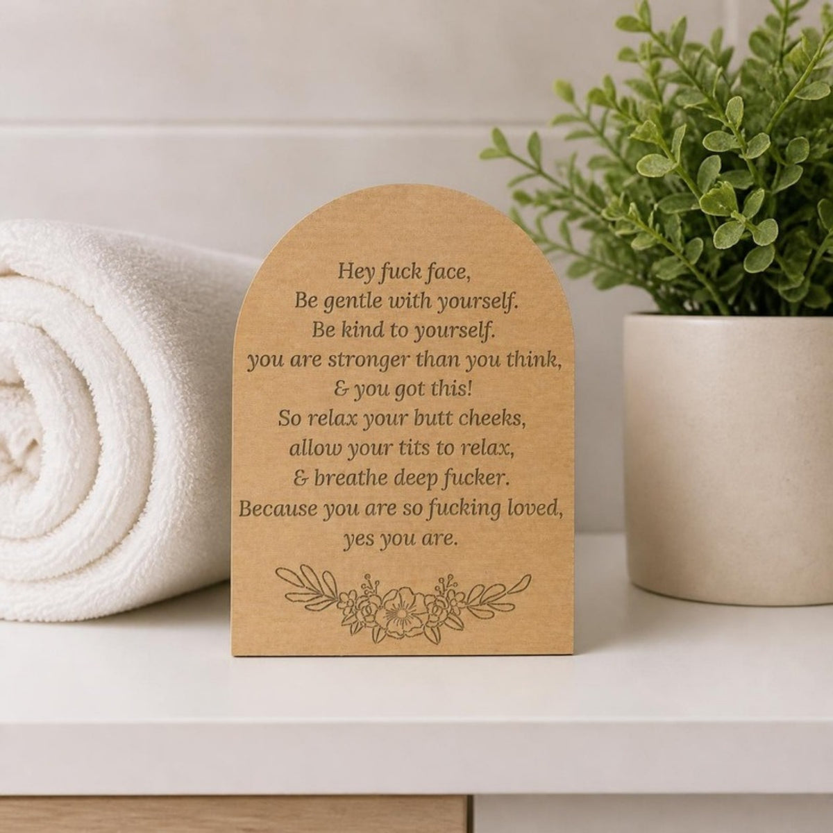Hey fuck face wooden shelf sitter on a bathroom shelf