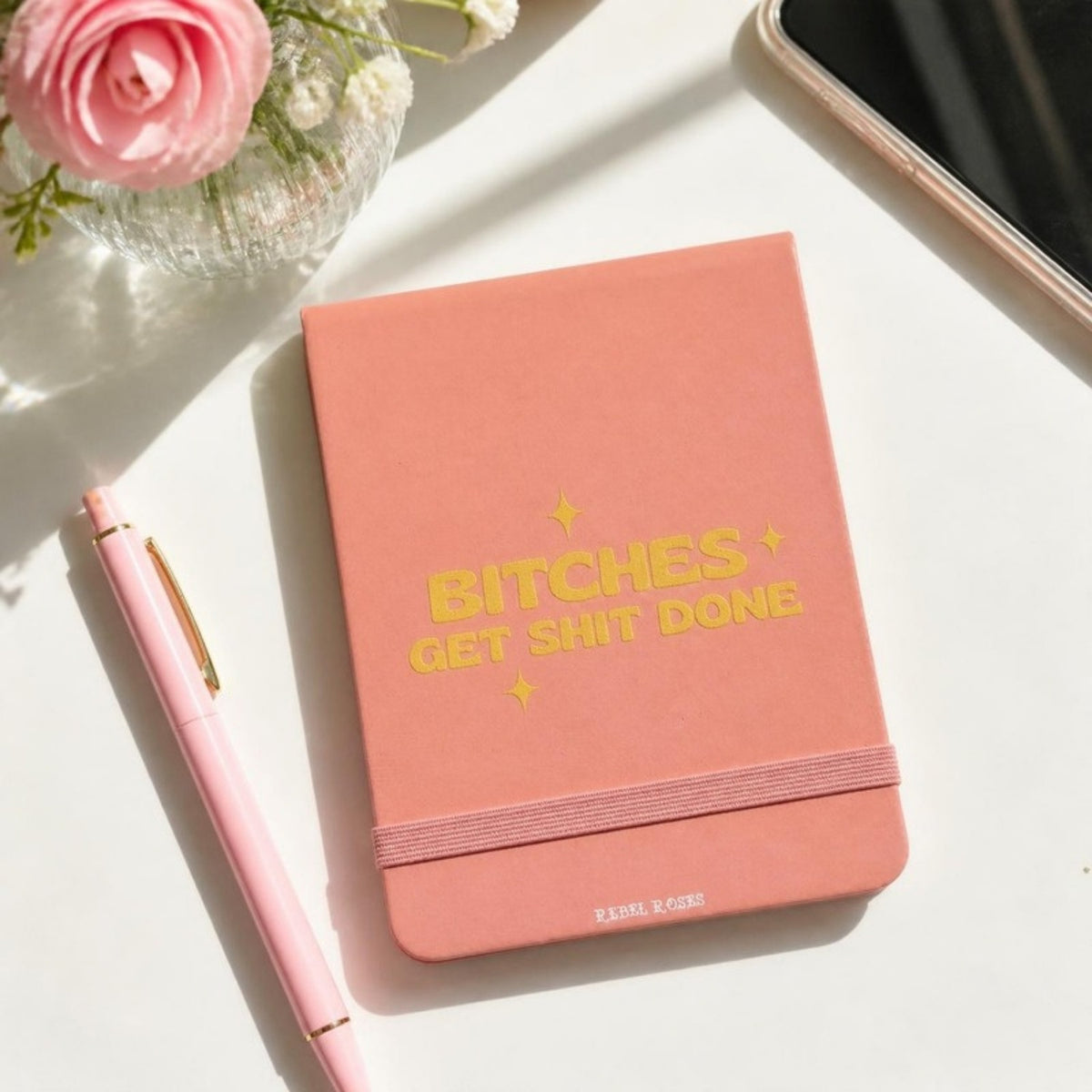 Bitches get shit done notepad on a desk