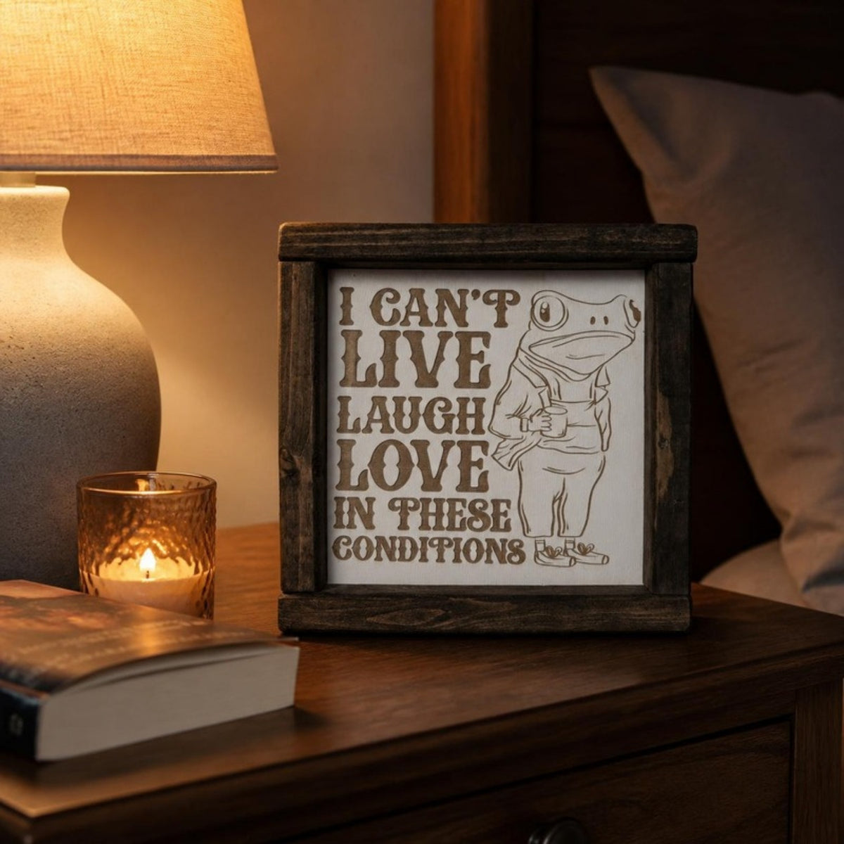 I can't live laugh love in these conditions framed sign on a nightstand