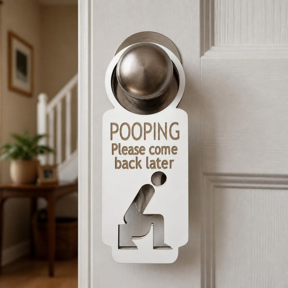 Pooping please come back later door knob hanger on a bathroom door