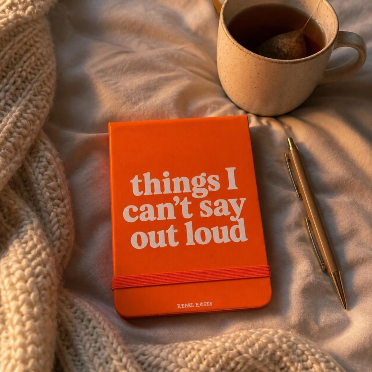 Things I can't say out loud notepad on a bed