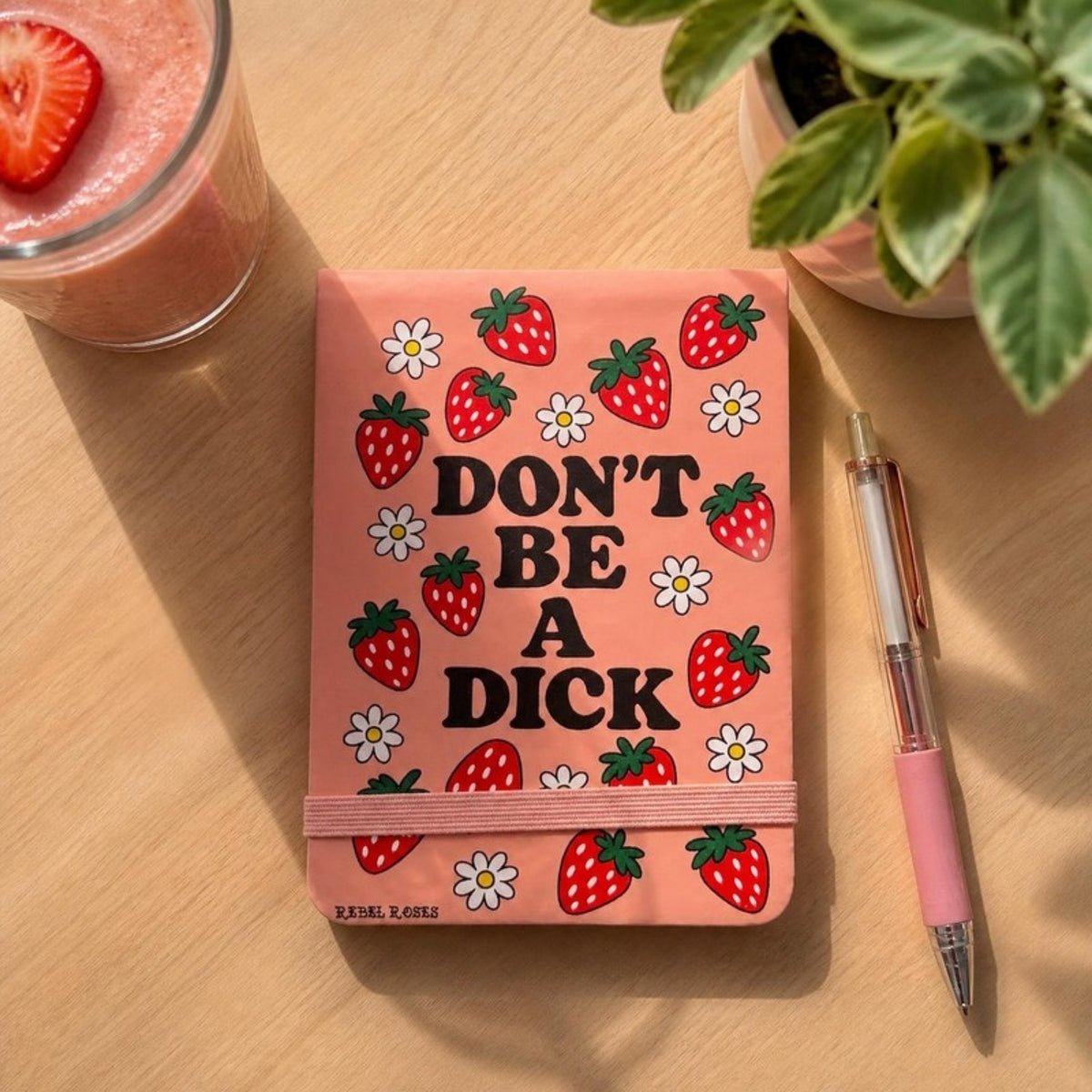 Don't be a dick strawberry notepad on a desk